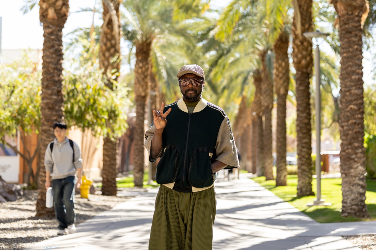 will.i.am holds up the pitchfork gesture on Palm Walk on the ASU Tempe campus